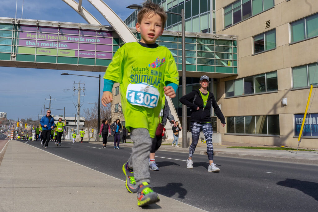 Little boy running by Southlake Bridge.